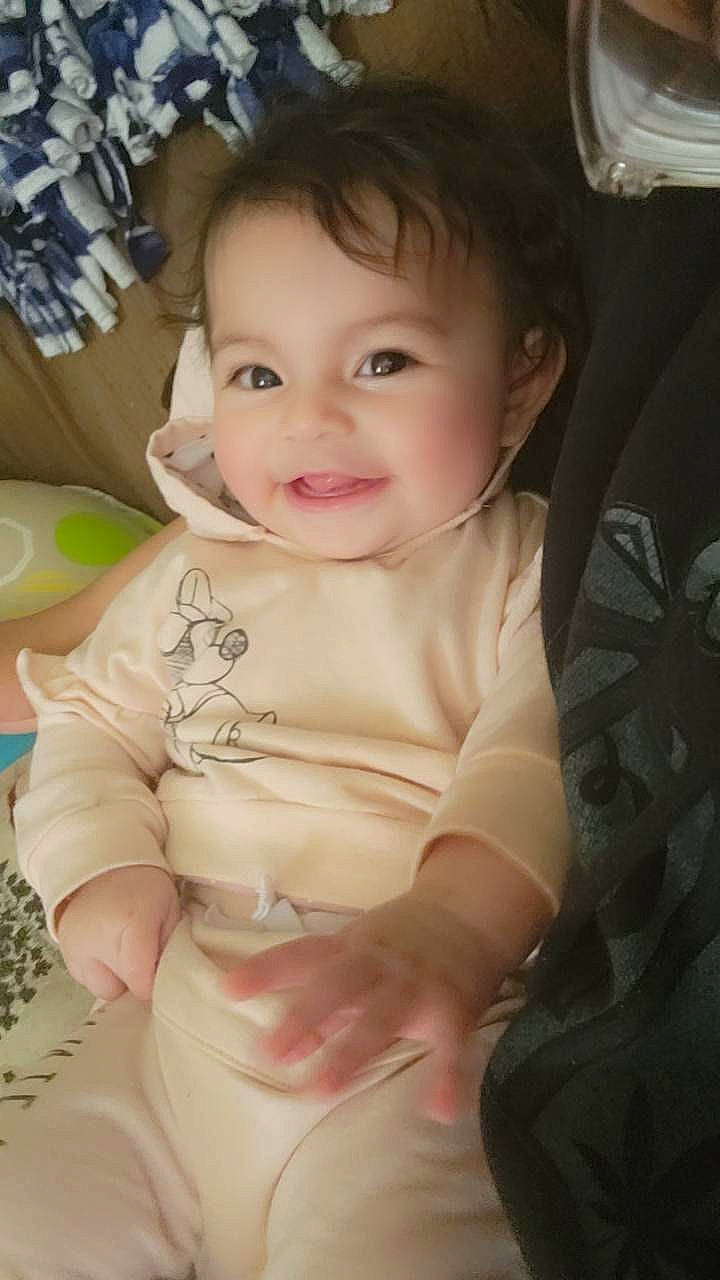 Laylani is registered to the contest to win money with this photo: baby, baby_toddler_clothing, cheek, child, chin, comfort, eye, eyebrow, eyelash, finger, happy, iris, joy, lip, nose, person, sitting, skin, sleeve, smile