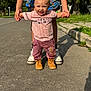 Jahkari joined the competition — help win amazing prizes! toddler, child, adult_hands, street, sunlight, walking, boots, pants, shirt, smiling, holding_hands, adult_legs, sidewalk, trees, outdoor, summer, shoes, person, happy, road