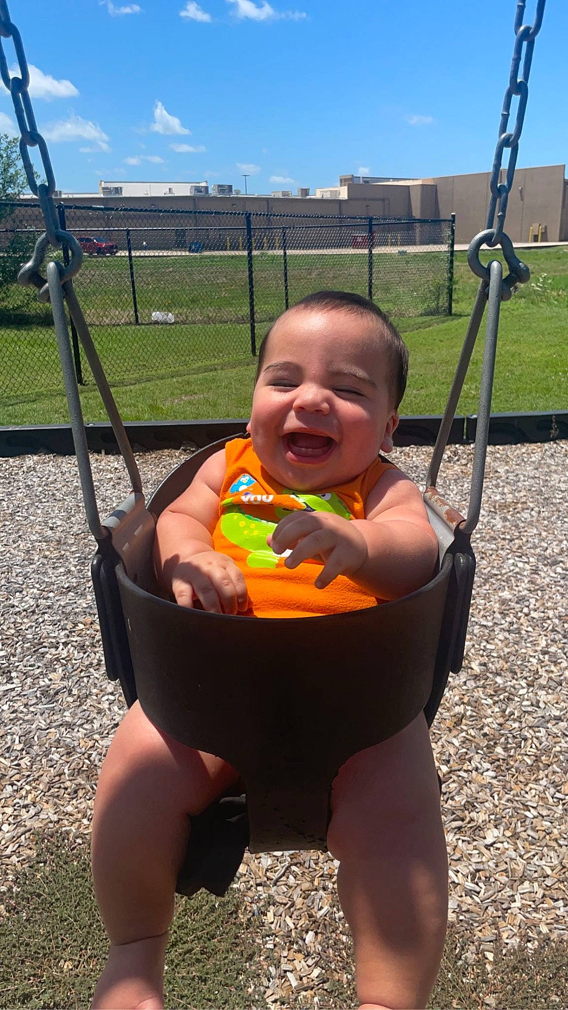 Kaiden joined the competition — help win amazing prizes! baby, baby_toddler_clothing, child, city, cloud, fun, grass, happy, leisure, outdoor_play_equipment, person, playground, recreation, sitting, sky, smile, summer, swing, thigh, thumb