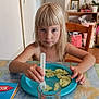 child, blonde_hair, blue_plate, cucumber_slices, plastic_fork, glass, cartoon_cat, table, tablecloth, chair, indoor, person, serious_face, food, meal, dining, room, furniture, sitting, young_child