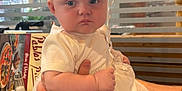 Delilah-Rose is registered to the contest to win money with this photo: baby, balloon, dress, hand, arm, tattoo, restaurant, menu, salt_shaker, table, window, person, clothing, face, child, sitting, indoor, white, cute, holding