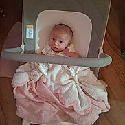 Justyna joined the competition — help win amazing prizes! baby, infant, child, high_chair, blanket, pink_blanket, sitting, portrait, face, eyes, looking_at_camera, indoor, home, wood_floor, furniture, cushion, baby_clothing, cozy, photography, cute