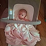 baby, infant, child, high_chair, blanket, pink_blanket, sitting, portrait, face, eyes, looking_at_camera, indoor, home, wood_floor, furniture, cushion, baby_clothing, cozy, photography, cute