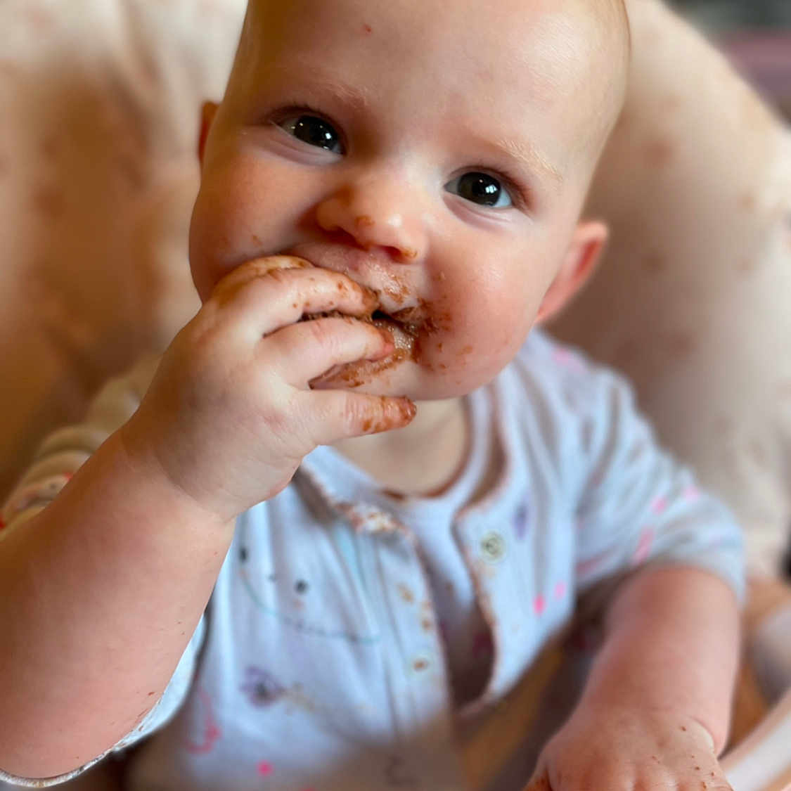 Harper is registered to the contest to win money with this photo: baby, biting, bodypart, cream, dessert, eating, face, finger, food, hand, head, icing, person, photography, portrait