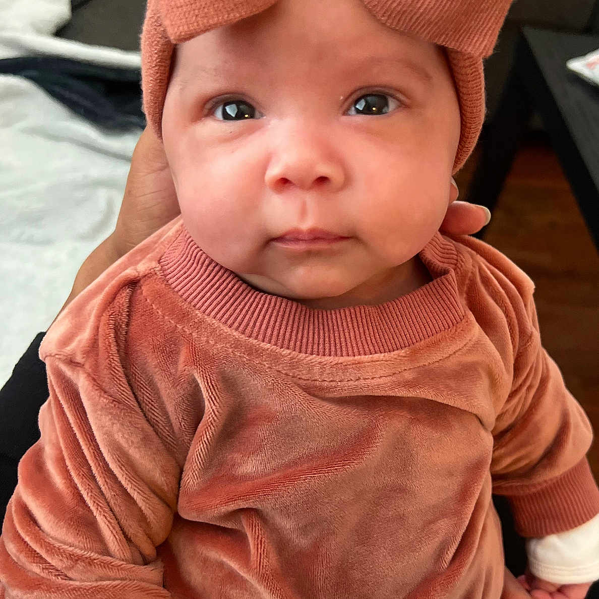 Melani is registered to the contest to win money with this photo: baby, beanie, bodypart, bonnet, cap, clothing, face, finger, hand, happy, hat, head, hoodie, knitwear, person, photography, portrait, smile, sweater, sweatshirt