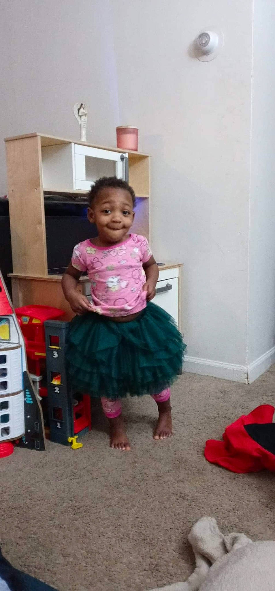 Amara is registered to the contest to win money with this photo: baby, baby_toddler_clothing, barefoot, child, floor, flooring, fun, happy, joy, magenta, person, pink, play, purple, room, sitting, sleeve, smile, standing, toddler