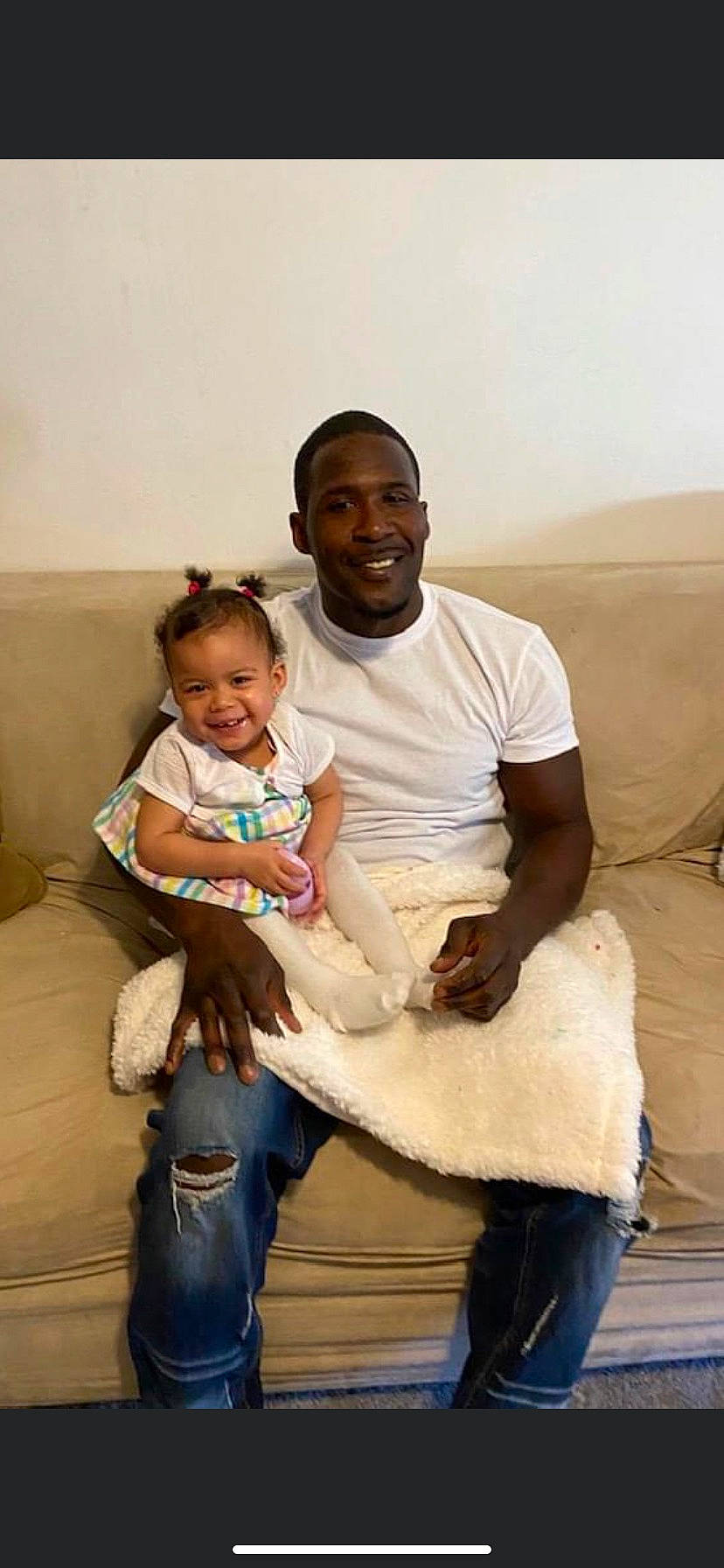 Amiya joined the competition — help win amazing prizes! baby, baby_toddler_clothing, child, comfort, couch, denim, event, family, fun, gesture, happy, joy, lap, person, room, sandal, shoulder, sitting, smile, t_shirt