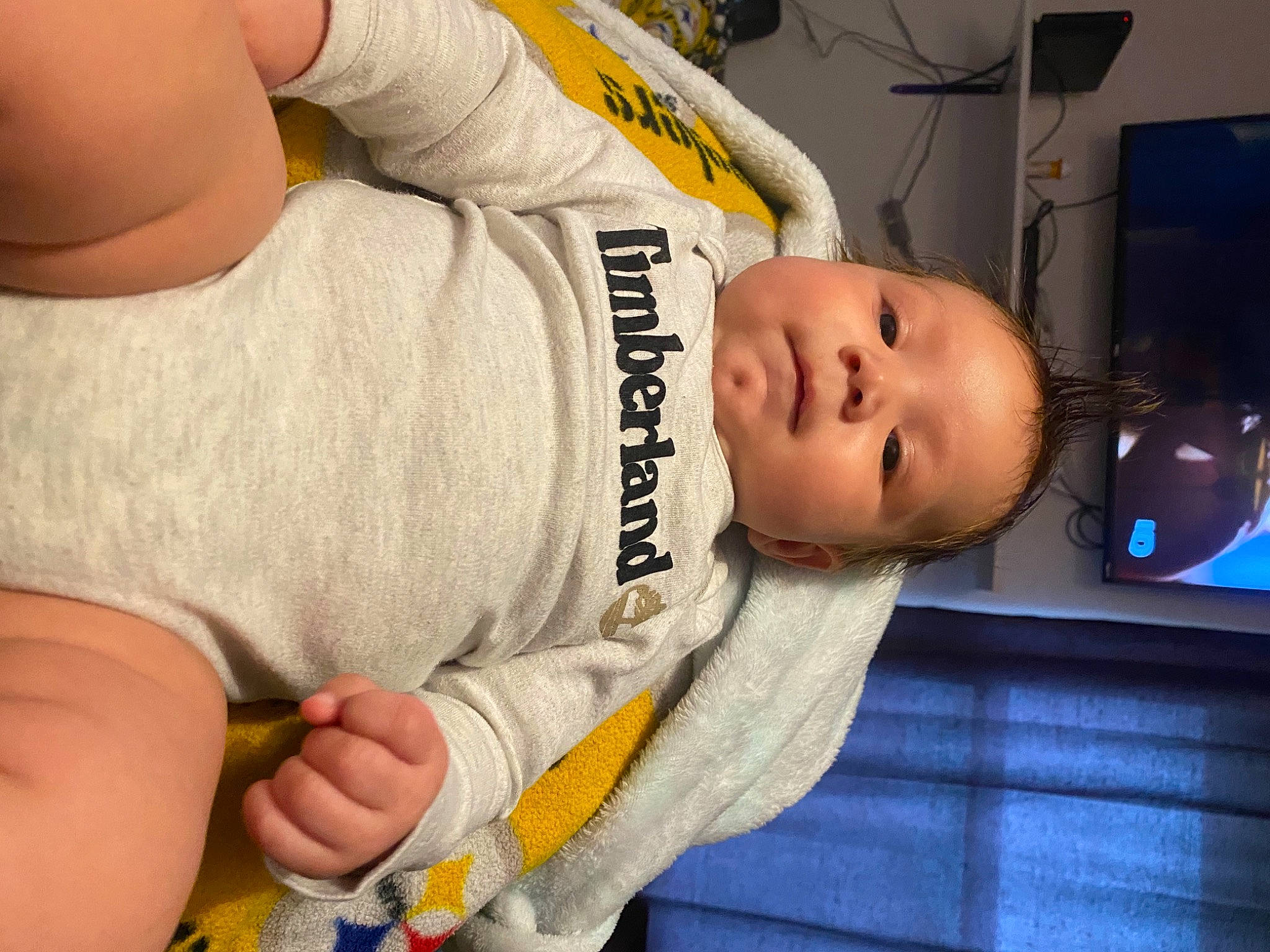 Kobe is registered to the contest to win money with this photo: abdomen, baby, baby_products, baby_toddler_clothing, cheek, chest, child, comfort, elbow, finger, gesture, hand, knee, nose, person, personal_protective_equipment, skin, sleeve, thumb, toddler