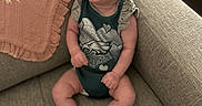Ava joined the competition — help win amazing prizes! baby, infant, child, smiling, laughing, sitting, couch, sofa, blanket, indoors, portrait, happy, face, eyes, clothing, onesie, socks, ruffles, furniture, cozy