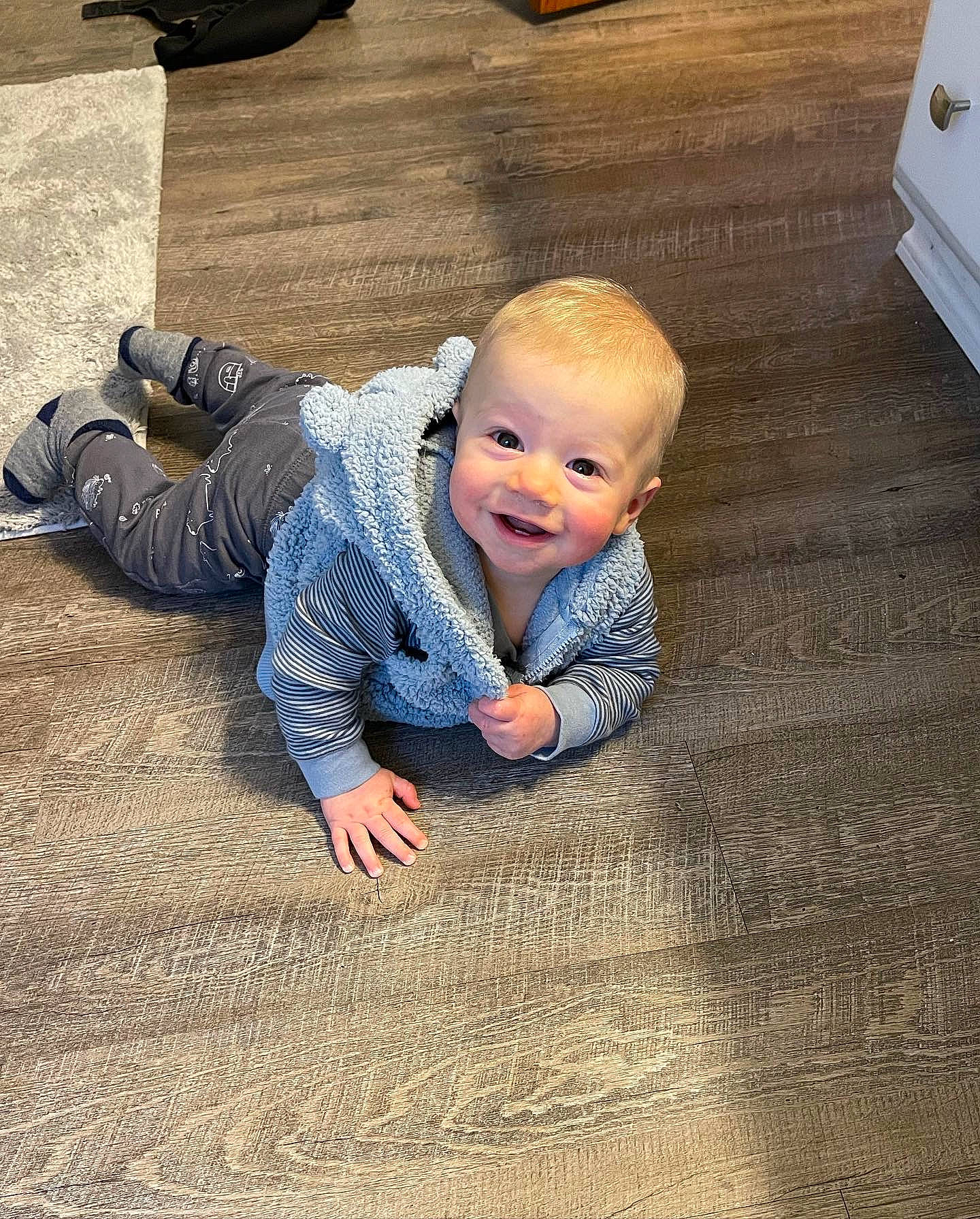 Bobby joined the competition — help win amazing prizes! asphalt, baby, baby_toddler_clothing, carpet, comfort, crawling, floor, flooring, fun, grass, hardwood, head, leg, people_in_nature, person, road_surface, sitting, skin, smile, toddler