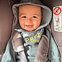 Andréas participe au concours pour gagner de l'argent avec cette photo : baby, babywear, car_seat, child, child_seat, clothing, cozy, cute, face, happy, hood, indoors, infant, person, portrait, seatbelt, sitting, smile, straps, young