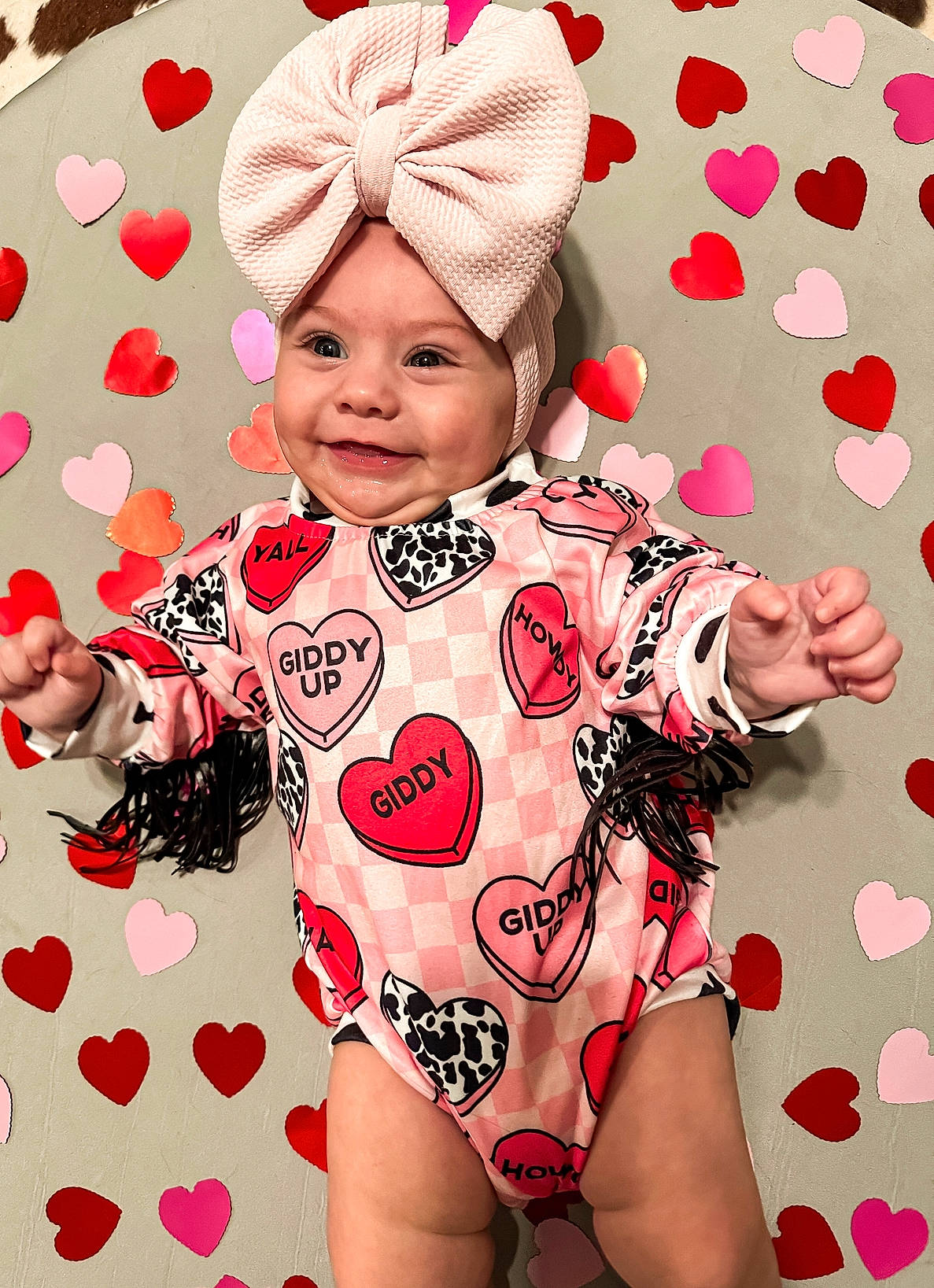 Sutton joined the competition — help win amazing prizes! baby, baby_toddler_clothing, cap, cool, eye, finger, fun, happy, head, headgear, headwear, human_body, joy, magenta, pattern, person, pink, skin, sleeve, textile