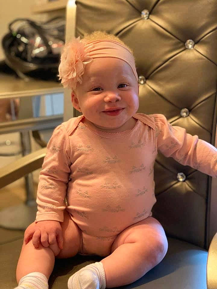 Jalani is registered to the contest to win money with this photo: arm, baby, blond, cheek, child, ear, person, sitting, skin, smile, toddler