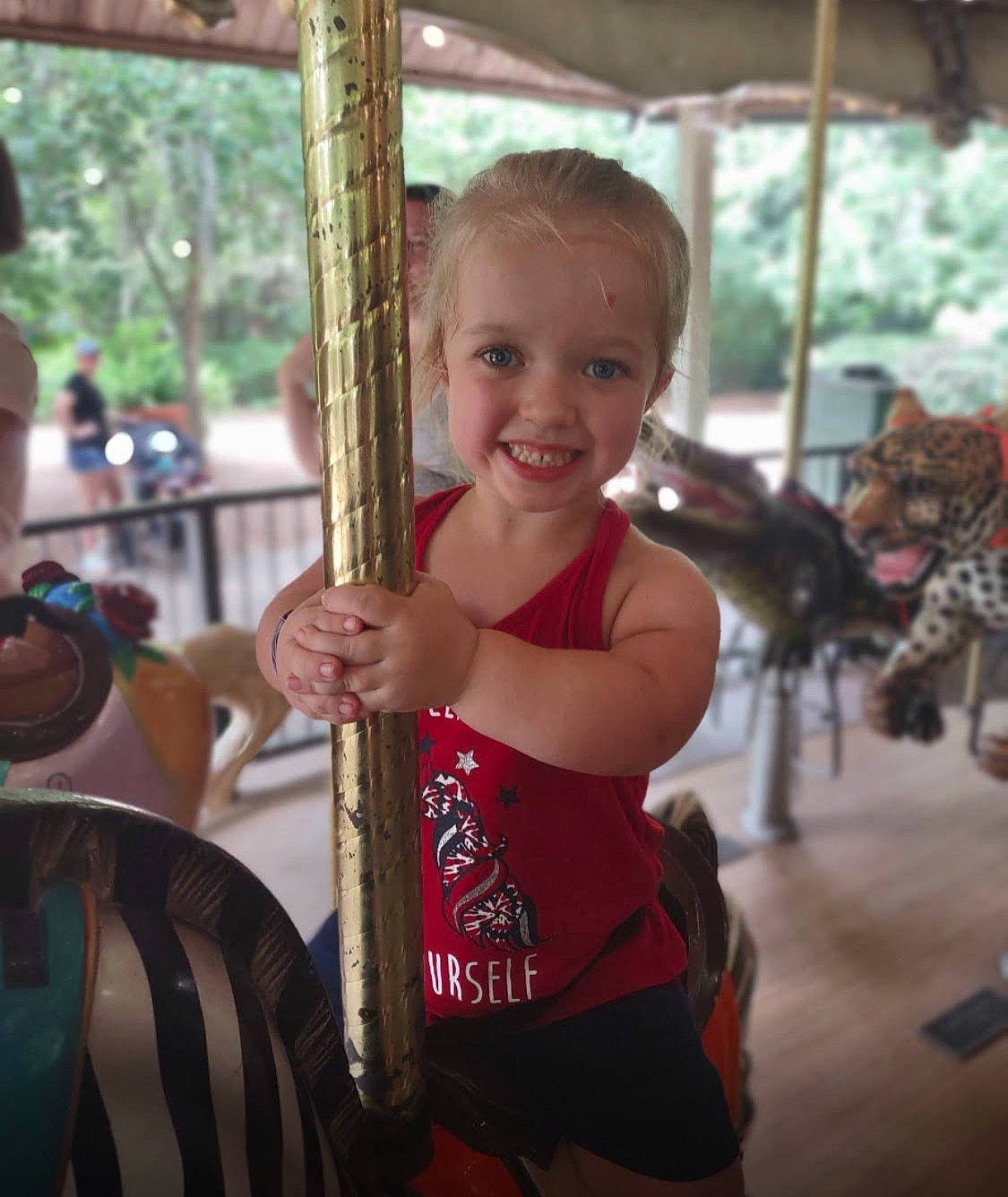 Hannah joined the competition — help win amazing prizes! amusement_park, amusement_ride, carousel, child, event, fun, happy, joy, leisure, nonbuilding_structure, person, playground, recreation, shorts, smile, t_shirt, temple, thumb, toddler, tree