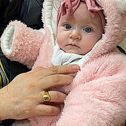 Ines a rejoint le concours — aidez-le/la à gagner de superbes lots ! baby, child, infant, pink, fluffy, hood, bear_ears, headband, blue_eyes, hand, ring, clothing, indoor, portrait, person, cute, warm, soft_texture, holding, looking