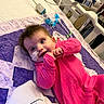 baby, infant, child, hospital, hospital_bed, pink_outfit, smiling, lying_down, portrait, medical_equipment, monitor, wires, electrodes, sensor, blanket, bedroom, indoor, face, eyes, healthy_expression