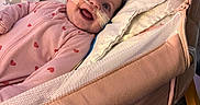Jaylee is registered to the contest to win money with this photo: baby, bassinet, bed, blanket, child, cozy, cute, face, happy, heart_pattern, indoor, infant, medical_tape, nasal_cannula, person, pink_onesie, plush_toy, rest, smile, soft_fabric