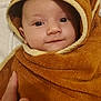 baby, child, towel, hooded_towel, brown, soft_texture, face, eyes, smile, hand, cute, infant, portrait, wrapped, warm, indoor, person, newborn, cozy, baby_clothing