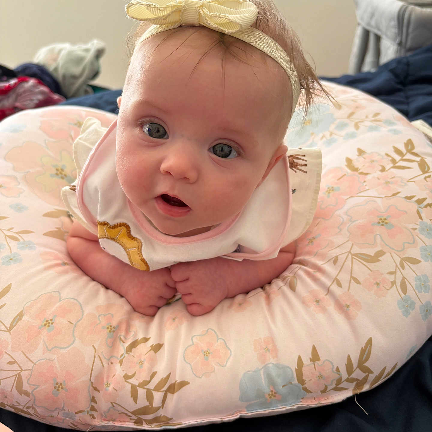 Cassidy joined the competition — help win amazing prizes! baby, bed, blanket, bow, clothing, cozy, cushion, cute, eyes, face, floral_pattern, hands, headband, indoors, infant, pastel_colors, pink, portrait, soft, young_child