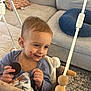 Rhett-Michael is registered to the contest to win money with this photo: child, toddler, cookie, chocolate, messy_face, smile, swing_seat, blanket, wooden_beads, sofa, pillow, carpet, hands, snack_time, indoor, living_room, portrait, seat, toy, happy