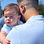 baby, child, man, holding, outdoor, sunlight, blue_sky, short_hair, white_shirt, light_blue_shirt, portrait, face, hand, skin, daylight, people, parent, family, toddler, close_up