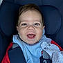 baby, child, smiling, car_seat, blue_bib, red_clothing, happy, infant, face, portrait, seatbelt, child_safety, indoor, cute, young_child, person, clothing, fabric, closeup, head