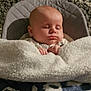 Martin is registered to the contest to win money with this photo: baby, sleeping, blanket, carpet, infant, cozy, child, face, hands, soft_texture, seat, resting, indoors, cute, peaceful, warm, comfort, portrait, head, closed_eyes