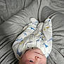 baby, infant, onesie, blanket, soft, sleepwear, cute, lying_down, indoors, child, newborn, face, head, skin, blue_eyes, plush, comfort, resting, peaceful, warm