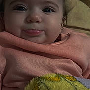 Olga participe au concours pour gagner de l'argent avec cette photo : baby, infant, face, eyes, eyelashes, smile, lips, cheeks, close_up, pink_clothing, blanket, cozy, bed, pillow, portrait, gaze, human, cute, pink_sweater, indoor