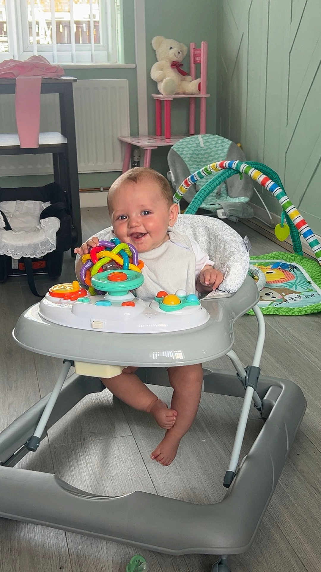 Hunter joined the competition — help win amazing prizes! baby, walker, toy, smile, indoor, floor, teddy_bear, chair, baby_toy, child, playful, happy, person, foot, colorful, window, radiator, flooring, baby_walker, baby_clothing