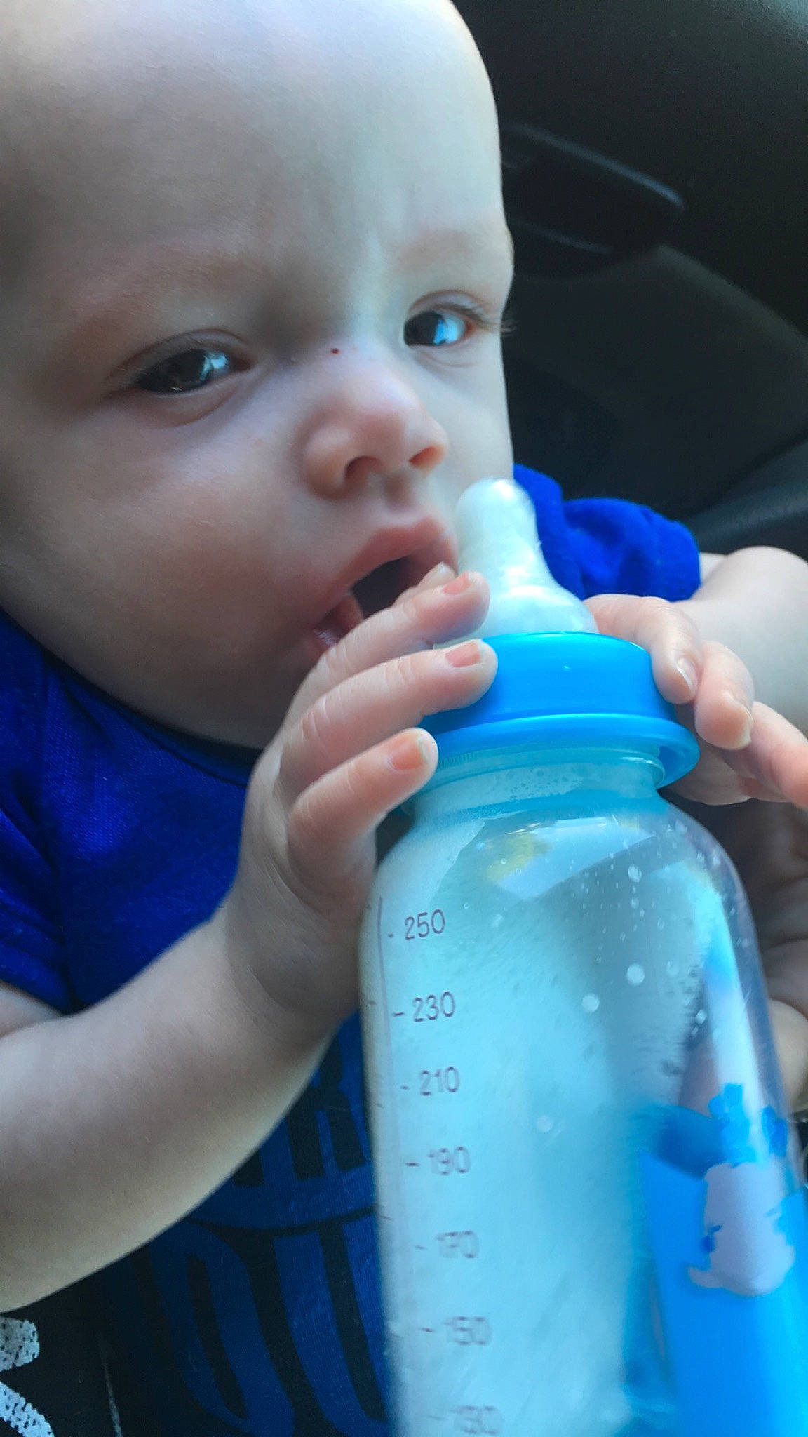Blake is registered to the contest to win money with this photo: baby, baby_bottle, baby_food, baby_products, bottle, child, dairy, drink, drinking_water, drinkware, infant_formula, milk, nose, person, plastic_bottle, product, skin, tableware, toddler, water