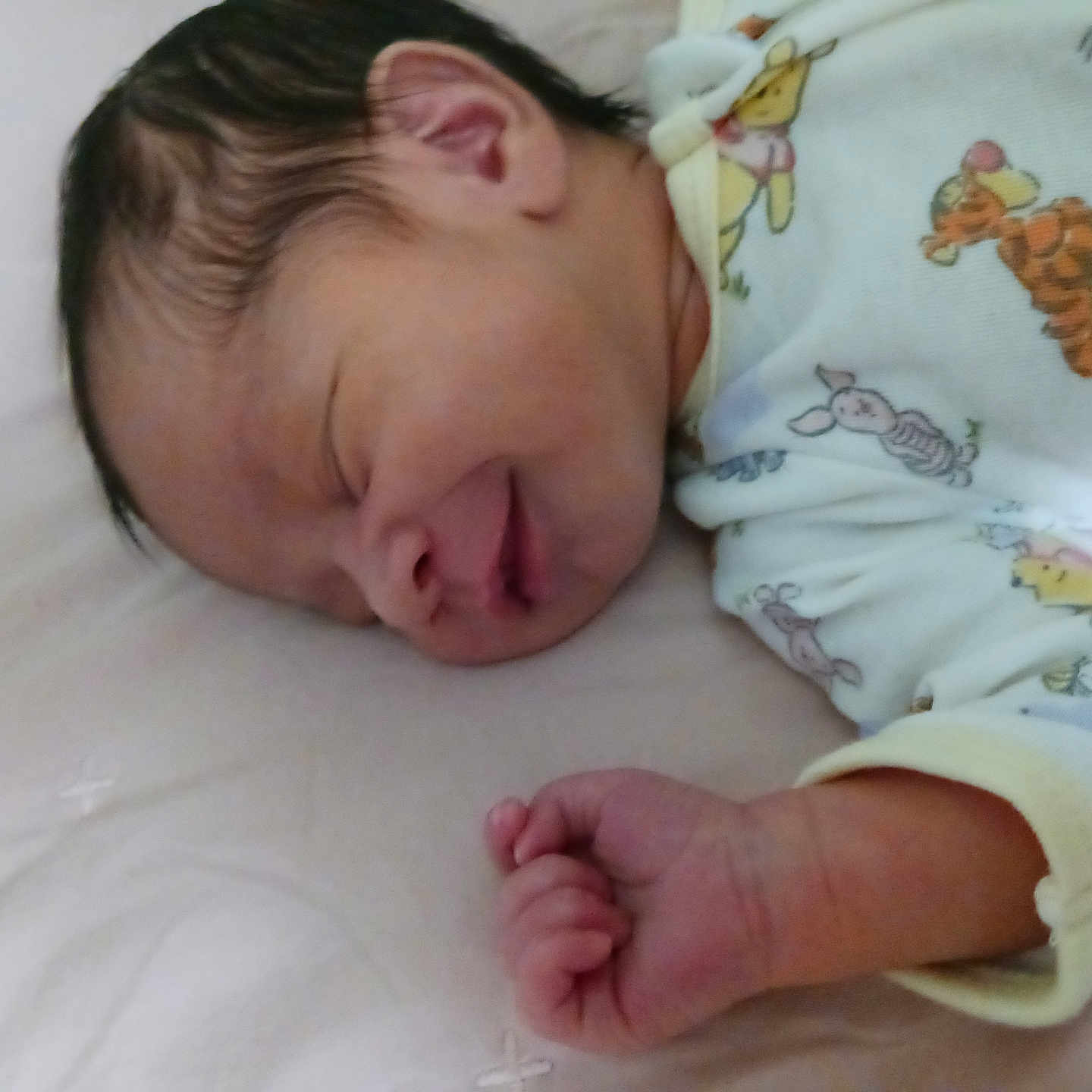 Kingston is registered to the contest to win money with this photo: newborn, baby, sleeping, infant, onesie, cartoon_characters, hand, face, peaceful, soft_surface, cute, cozy, child, portrait, resting, closeup, skin, hair, indoors, toddler