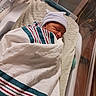 Kingston is registered to the contest to win money with this photo: newborn, baby, hospital, bassinet, blanket, hat, sleeping, infant, swaddled, bed, cotton, resting, cute, striped_blanket, human, child, soft, healthcare, nursery, indoor