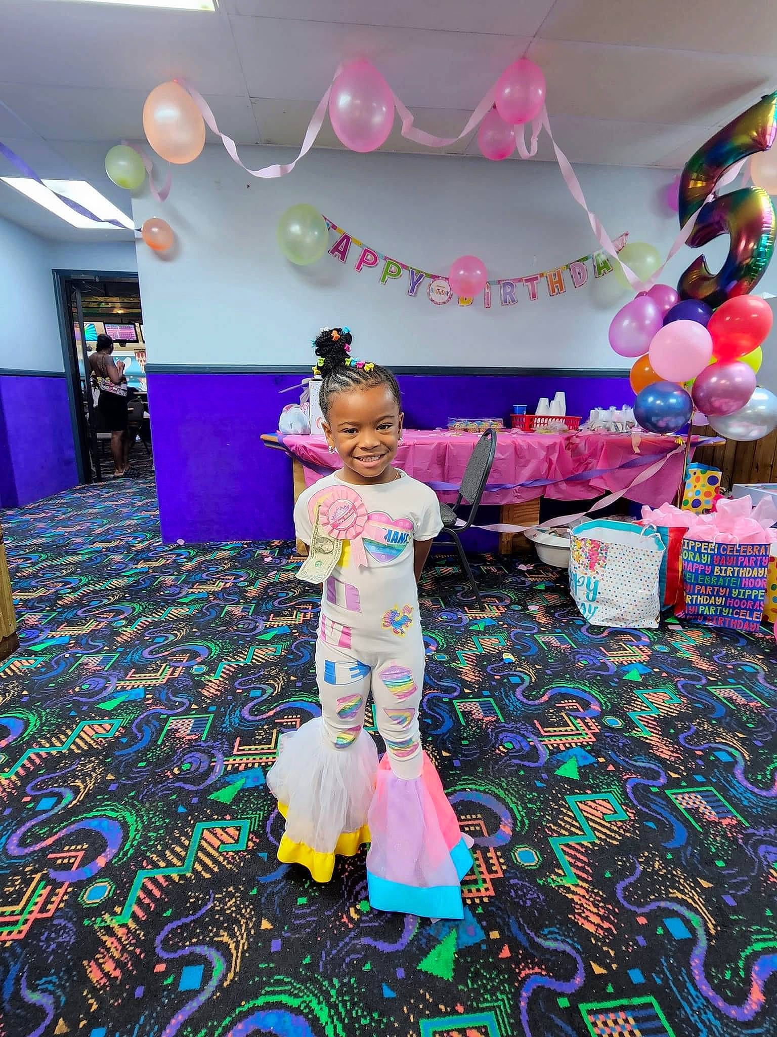 Armani is registered to the contest to win money with this photo: balloon, carpet, child, decoration, electric_blue, entertainment, event, fashion_design, floor, flooring, fun, happy, joy, leisure, magenta, party_supply, person, pink, purple, toddler