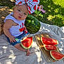 baby, child, watermelon, bow, outdoor, picnic, blanket, grass, tree, fruit, summer, cute, jeans, sleeveless_shirt, shadows, sunlight, basket, food, sitting, nature