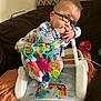 Makayla joined the competition — help win amazing prizes! baby, glasses, toy, baby_seat, colorful, hand, couch, blanket, indoor, cute, child, face, clothing, earring, playtime, infant, expression, home, comfort, curious
