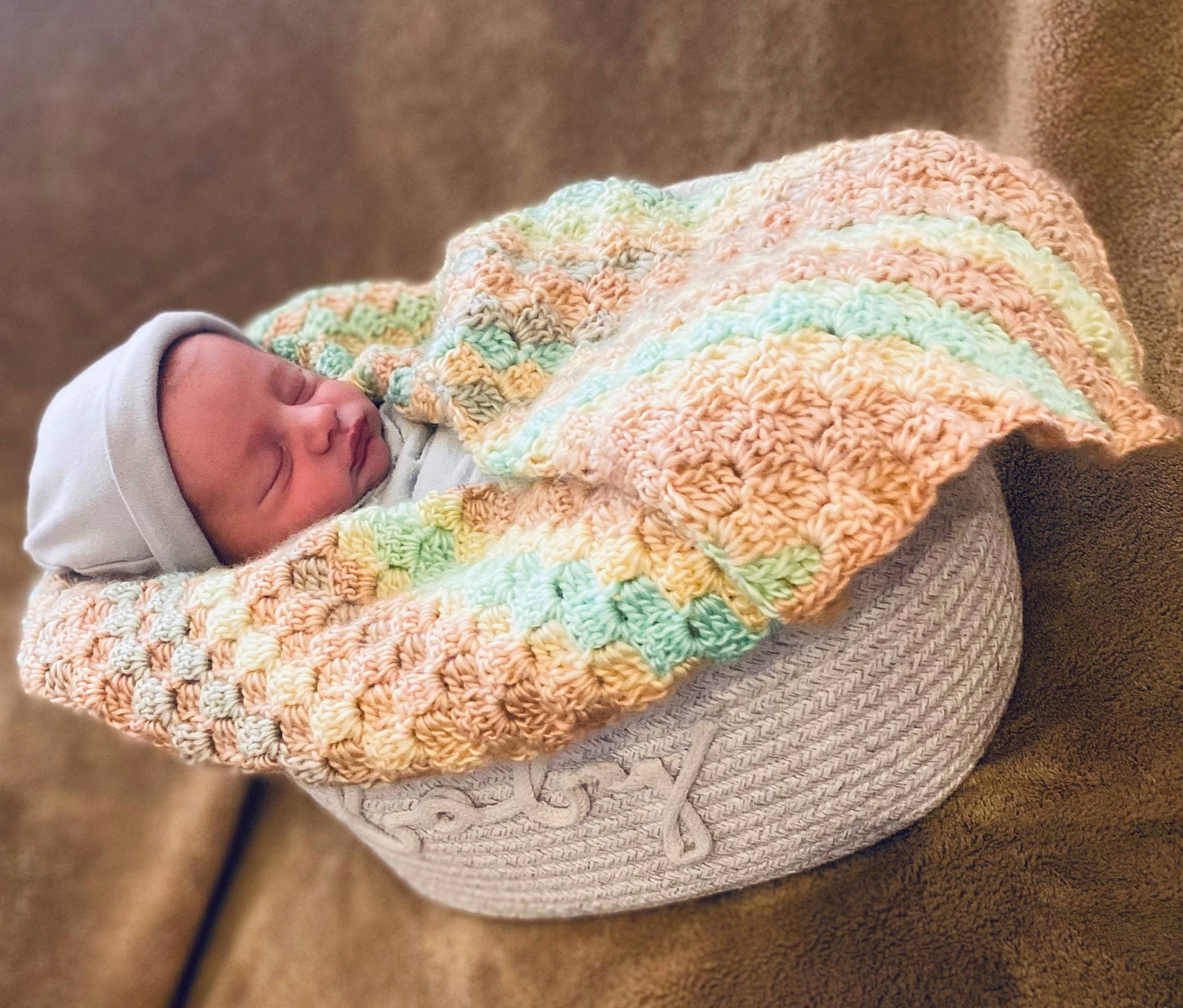 Leum is registered to the contest to win money with this photo: art, baby, baby_toddler_clothing, cap, comfort, fashion_accessory, fur, grass, hat, headgear, headwear, knit_cap, linens, outerwear, pattern, person, sleeve, textile, thread, wood