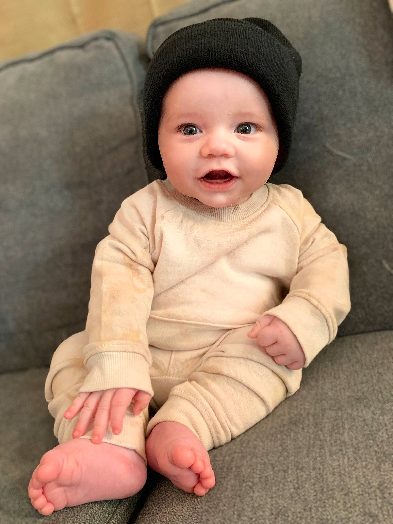 Keagan is registered to the contest to win money with this photo: baby, baby_toddler_clothing, cheek, comfort, eye, eyebrow, face, flash_photography, flooring, gesture, happy, head, headwear, lip, nose, outerwear, person, skin, sleeve, smile
