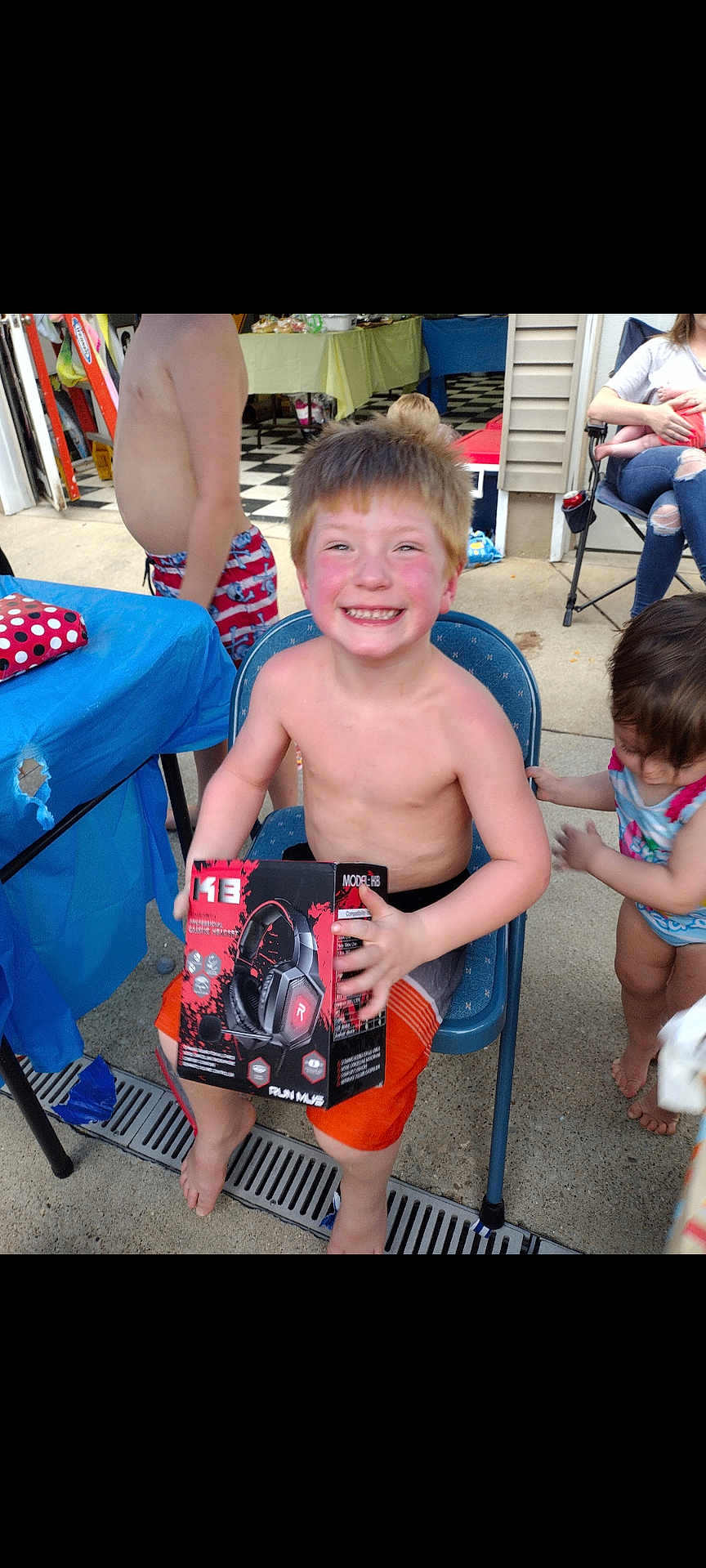 Liam joined the competition — help win amazing prizes! adult, baby, bodypart, box, boy, child, clothing, face, female, finger, hand, head, male, pants, person, photography, portrait, shorts, t_shirt, woman