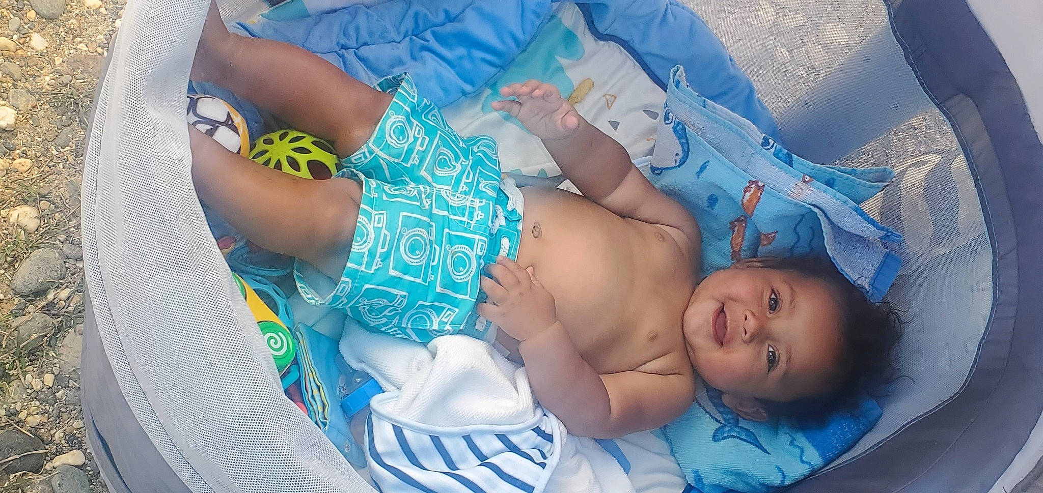 Cash is registered to the contest to win money with this photo: abdomen, aqua, azure, baby, blue, child, comfort, electric_blue, event, finger, human_leg, joint, joy, mouth, pattern, person, skin, stomach, textile, thigh