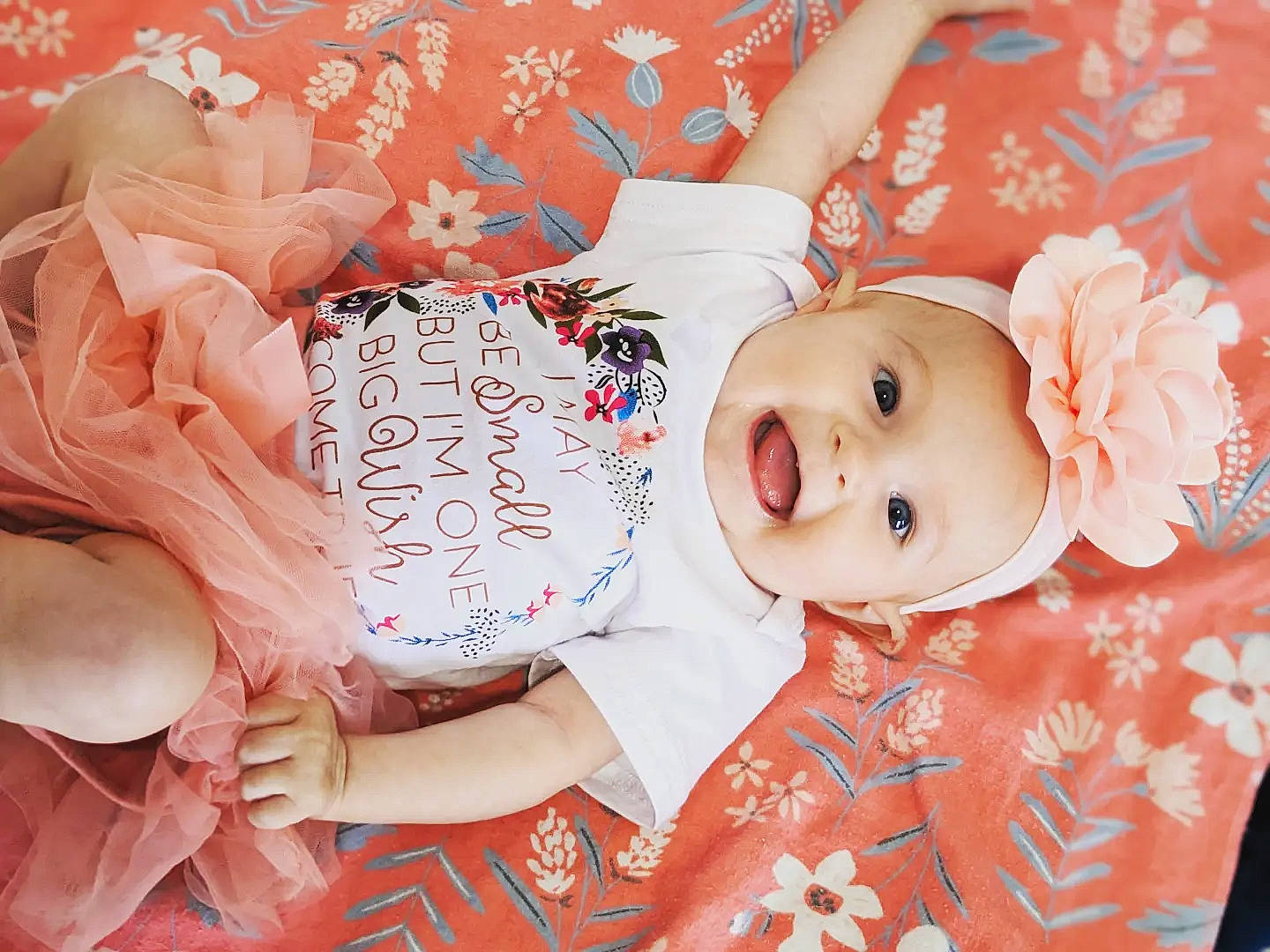 Genesis is registered to the contest to win money with this photo: baby, baby_products, baby_toddler_clothing, cheek, child, facial_expression, happy, head, headwear, human, lip, mammal, organ, pattern, peach, person, pink, skin, smile, sweetness