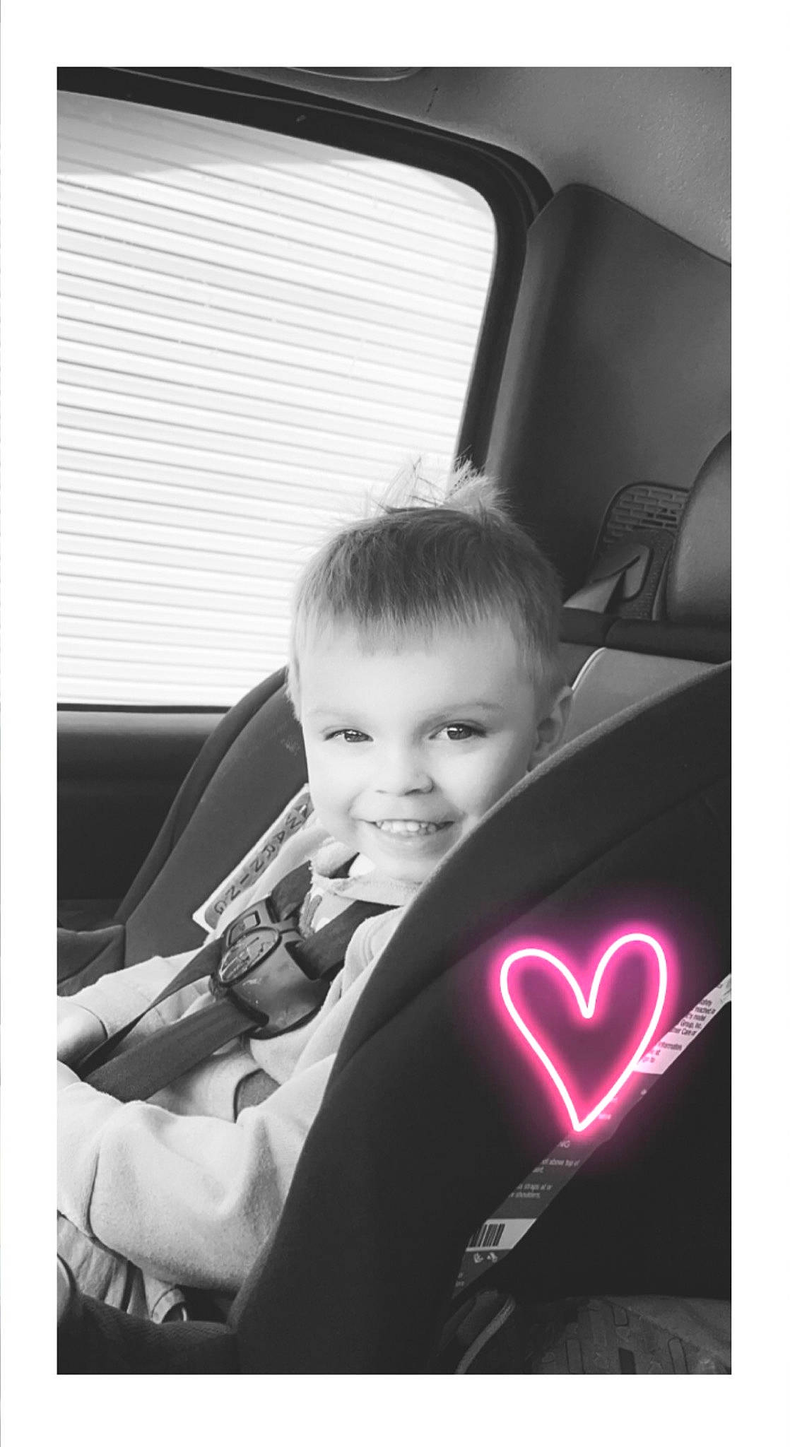 Riley is registered to the contest to win money with this photo: automotive_design, black, car_seat, child, family_car, flash_photography, formal_wear, fun, happy, joy, monochrome, monochrome_photography, motor_vehicle, person, room, sitting, suit, t_shirt, tints_and_shades, toddler