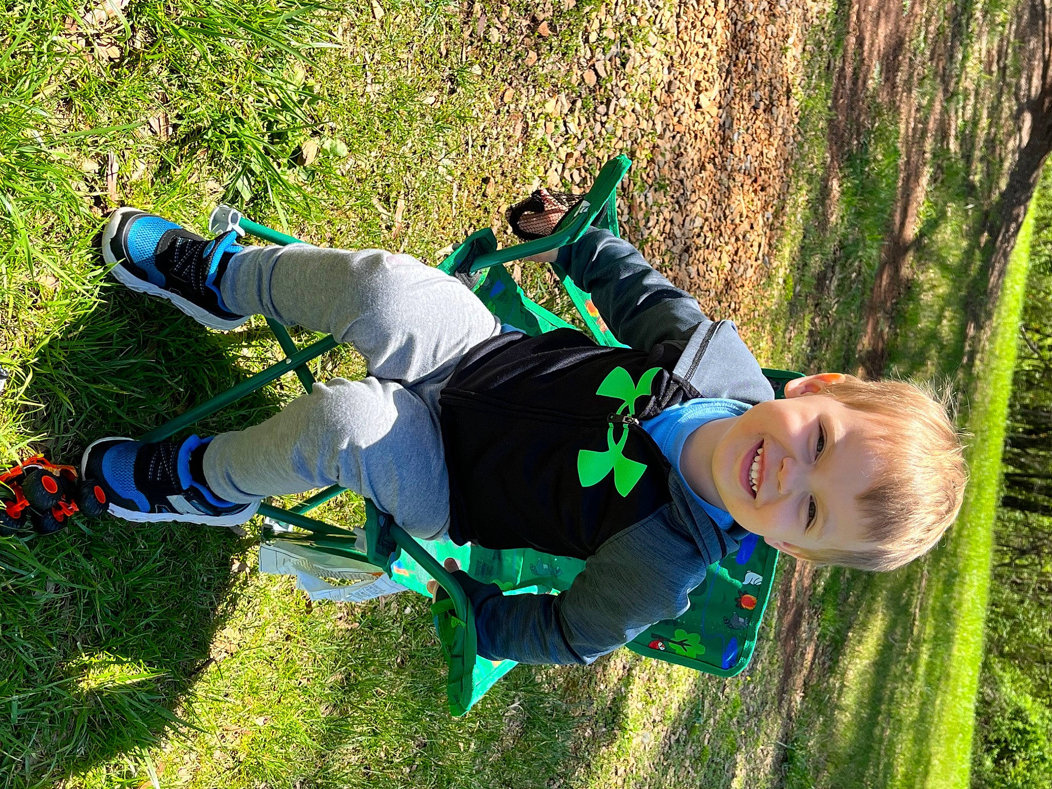 Riley is registered to the contest to win money with this photo: child, electric_blue, fun, grass, grass_family, grassland, happy, human_leg, joy, knee, lawn, leaf, leisure, people_in_nature, person, plant, recreation, smile, sneakers, sock