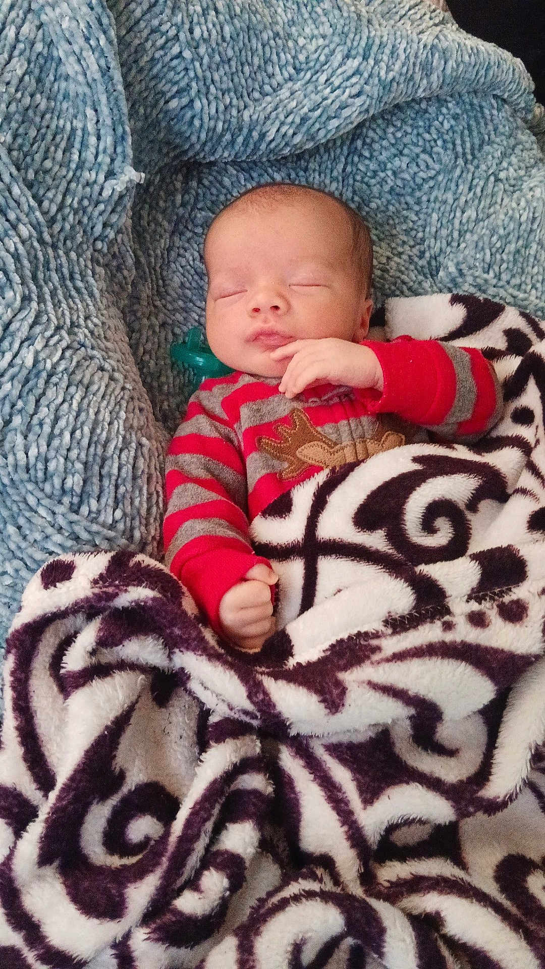 Tru'Amor joined the competition — help win amazing prizes! baby, sleeping, blanket, cozy, infant, red_striped_clothing, reindeer_design, soft_texture, peaceful, wrapped, cute, child, portrait, warm, indoors, resting, hand_near_face, head, face, newborn