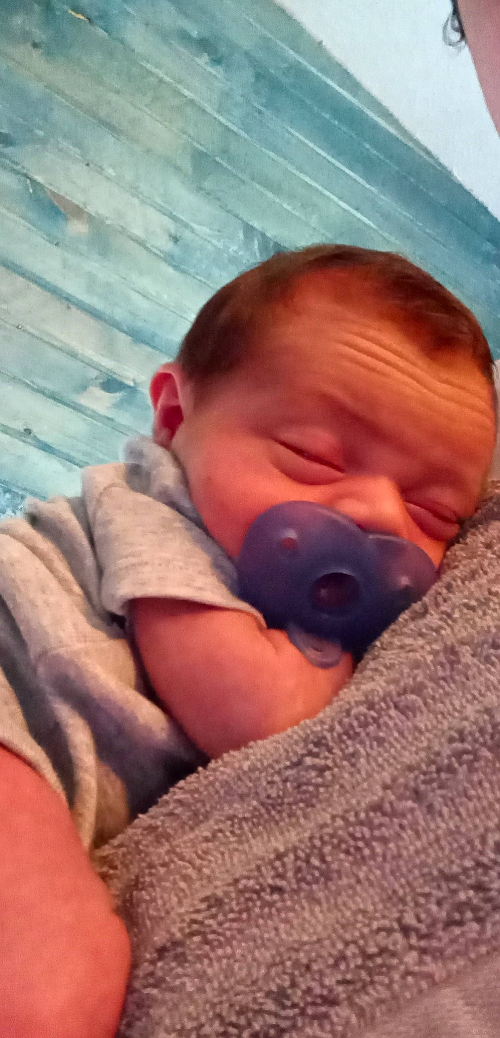 Axton is registered to the contest to win money with this photo: baby, baby_toddler_clothing, bedtime, cheek, child, chin, comfort, ear, eyebrow, finger, iris, linens, mouth, neck, nose, person, room, sitting, skin, toddler