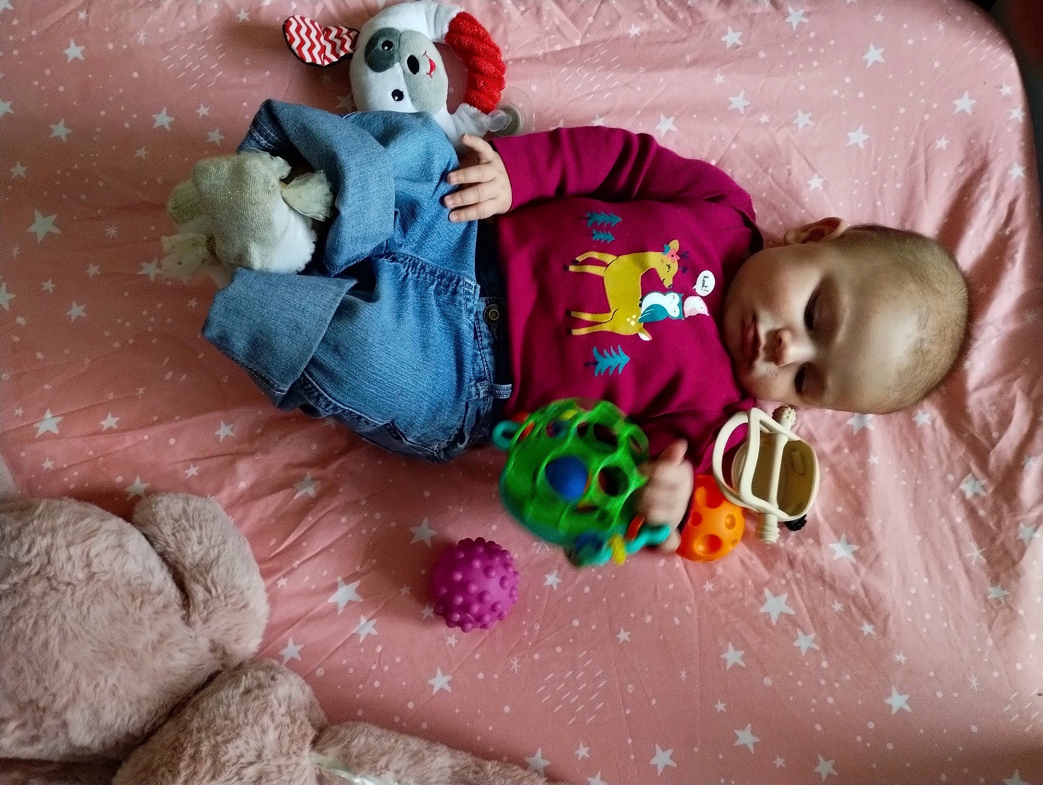 Athena is registered to the contest to win money with this photo: arm, baby, baby_toddler_clothing, baby_toys, child, comfort, eye, fun, happy, human_body, linens, mammal, organ, person, pink, purple, room, snapshot, textile, toddler