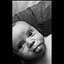 Kingsley is registered to the contest to win money with this photo: baby, tongue, face, black_and_white, close_up, infant, eyes, skin, expression, cute, portrait, child, texture, fabric, playful, adorable, head, person, monochrome, young