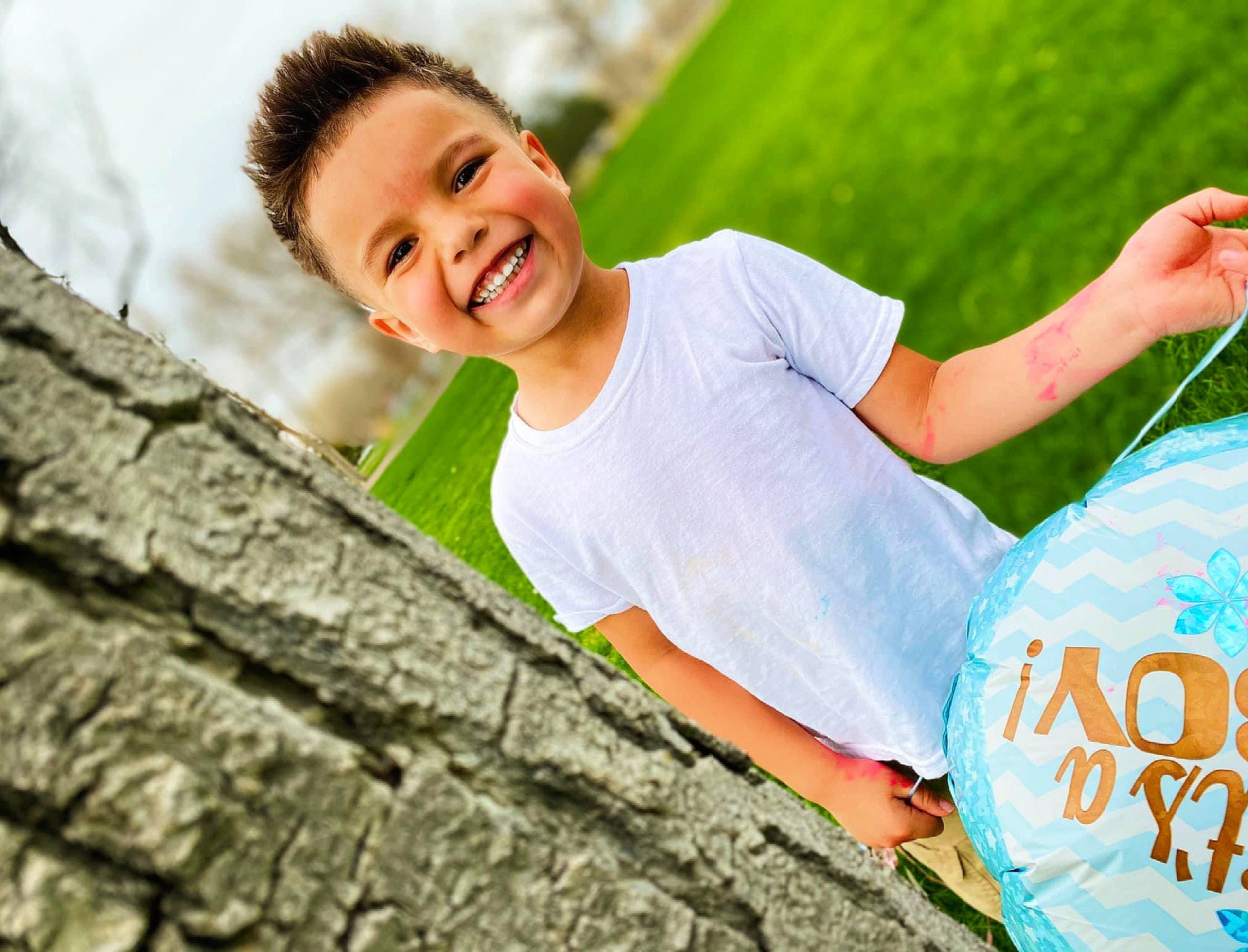 Elijah is registered to the contest to win money with this photo: adaptation, dress, fun, grass, happy, human_body, jeans, joy, leaf, leisure, nature, people, people_in_nature, person, plant, shorts, smile, sunlight, t_shirt, tree