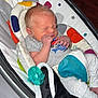 Christopher joined the competition — help win amazing prizes! newborn, baby, infant, sleeping, baby_seat, blanket, pacifier, clothing, indoor, cushion, colorful, person, cute, small_hands, soft, resting, peaceful, baby_garment, closeup, comfort