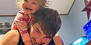 Amari joined the competition — help win amazing prizes! toddler, man, child, smiling, happy, indoor, tank, aquarium, tattoo, black_shirt, star_decoration, playful, family, bonding, casual, hair, hand, face, person, room